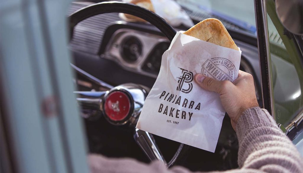 Hand holding Pinjarra Bakery pie